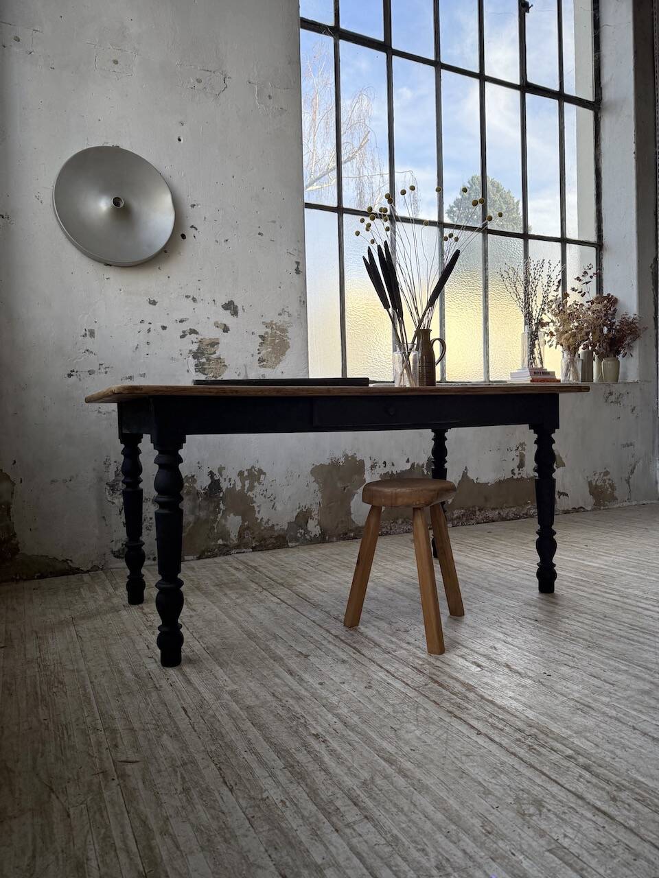 Oak farmhouse table with turned black legs.