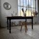 Oak farmhouse table with turned black legs.