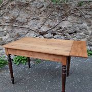 Vintage pine table with drop-leaf extension and turned beech legs, France, 1930s.