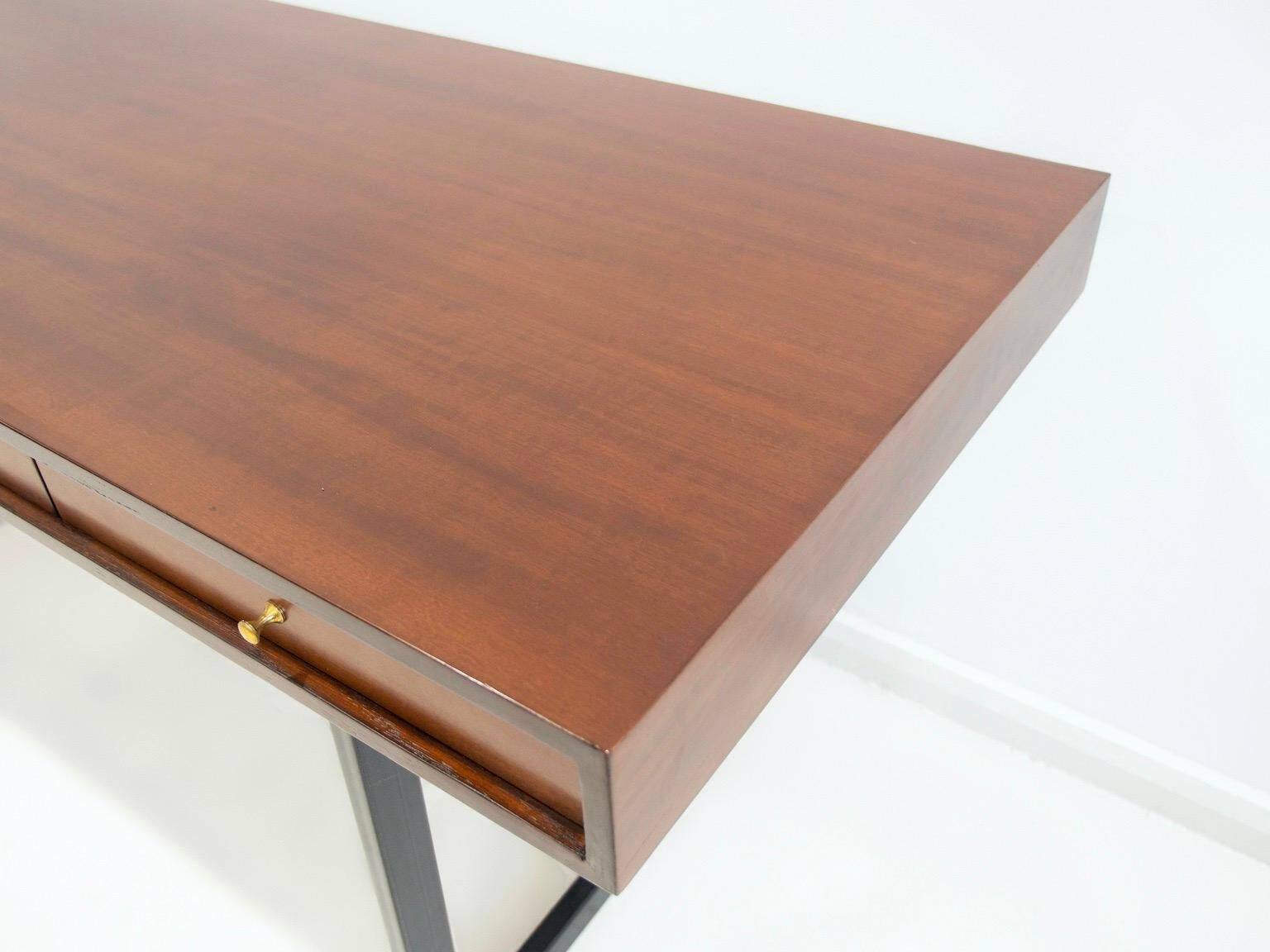 Wooden desk with drawers and black lacquered legs.