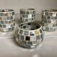 Four mosaic mirror and mother-of-pearl candle holders.