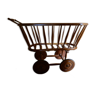 Old cradle baby varnished wood with wooden wheels