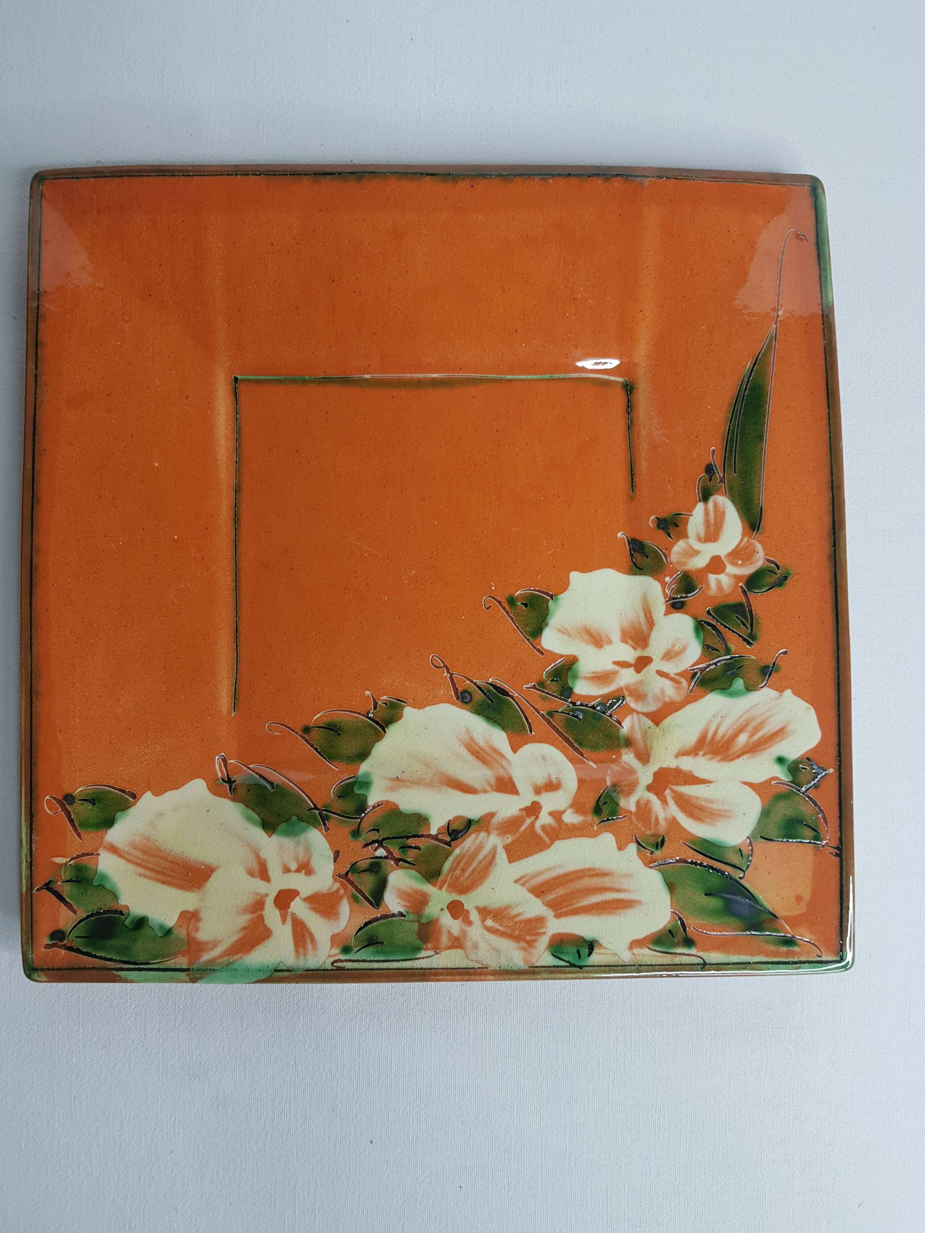 Dish or plate Pottery Galtié enamelled terracotta decorated with flowers, 24.5 cm