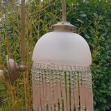 Brass swan neck wall lamp with pink glass globe and Charleston tassels