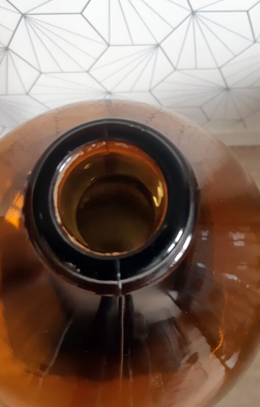 Great old demijohn in amber glass