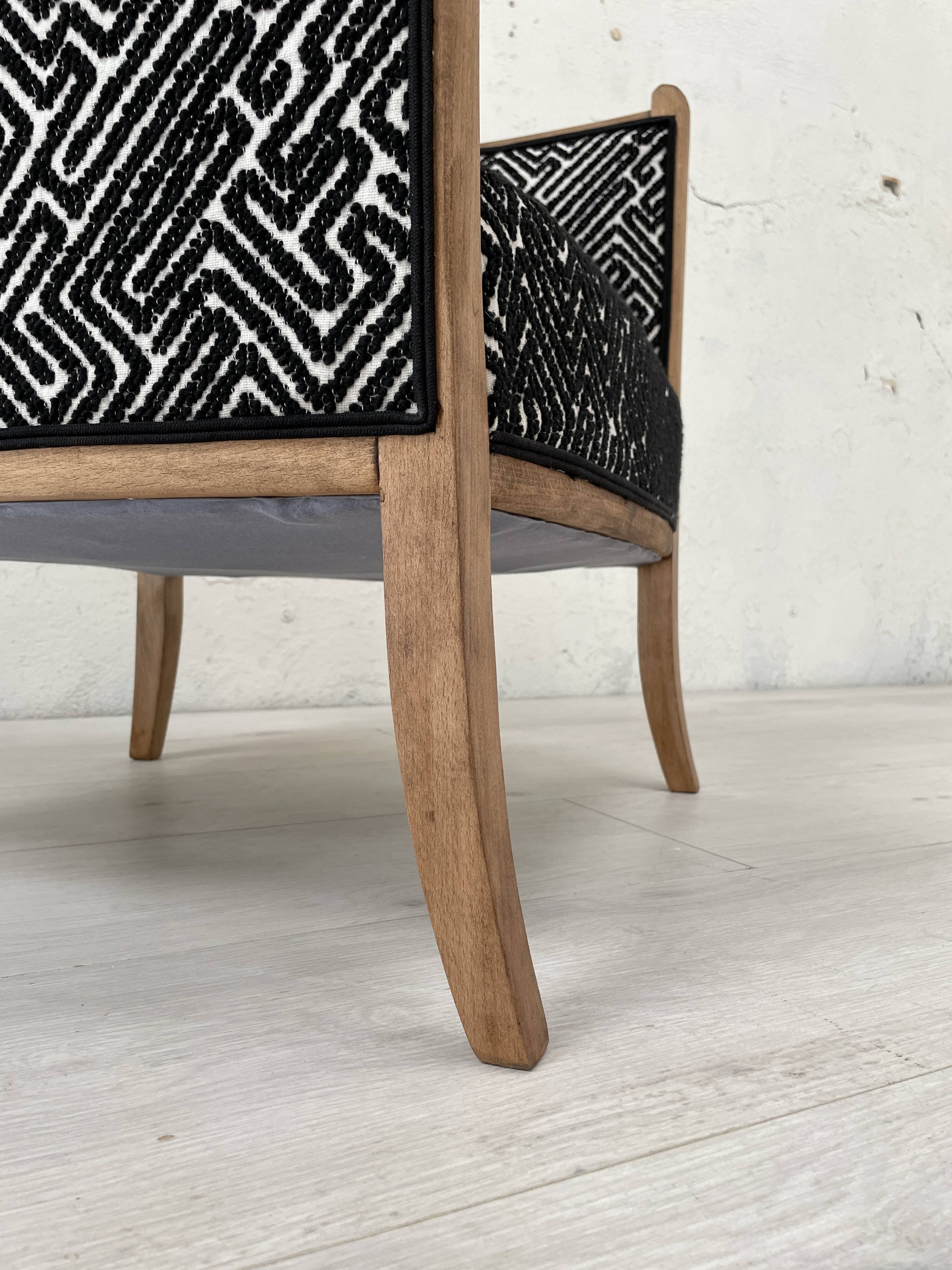 Club armchair in wood and fabric.
