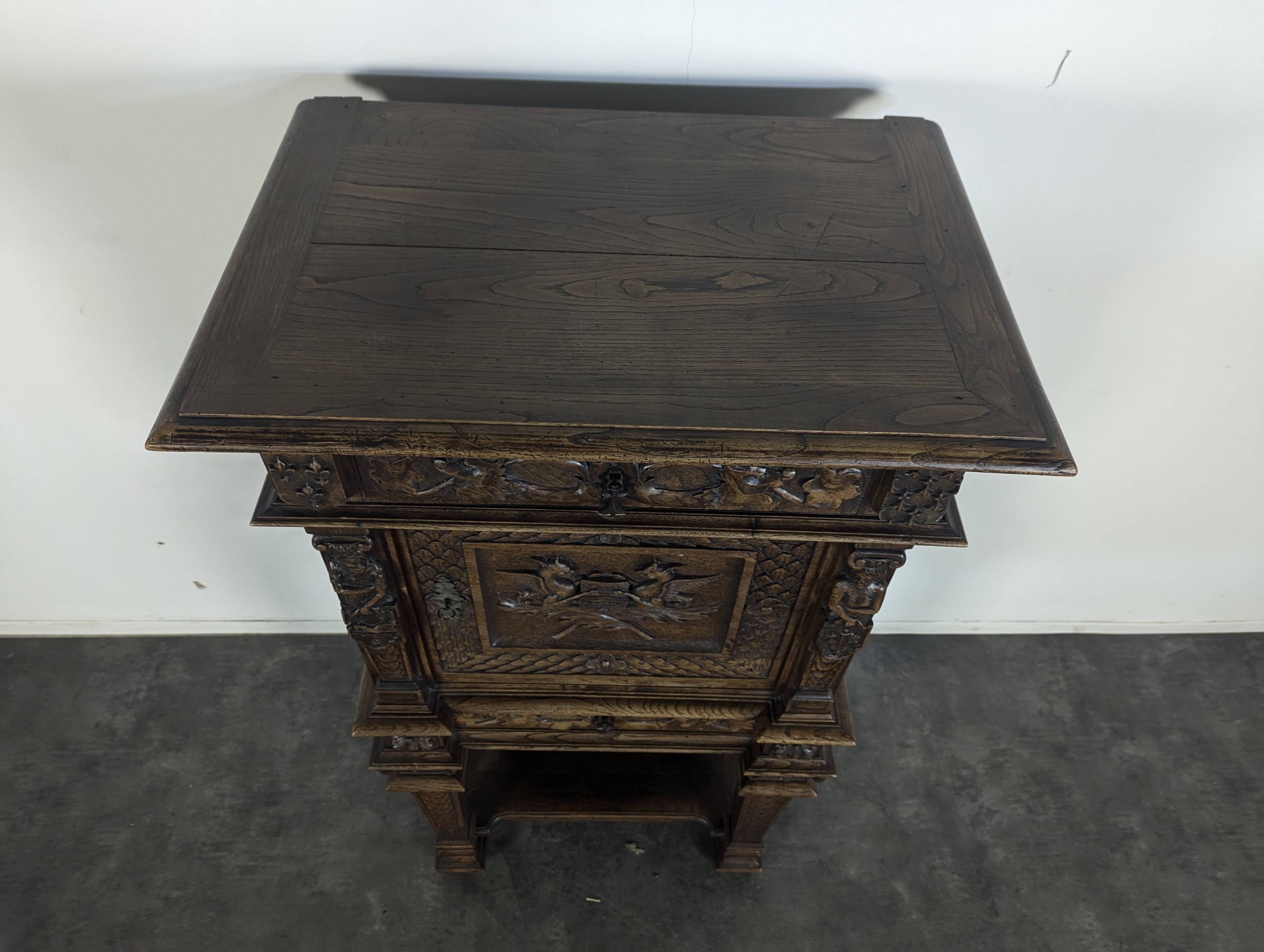 Renaissance-style cabinet in solid oak decorated with chimeras and caryatids