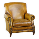 Fauteuil confortable de style anglais en cuir jaune de grande taille avec une finition soignée et des clous décoratifs