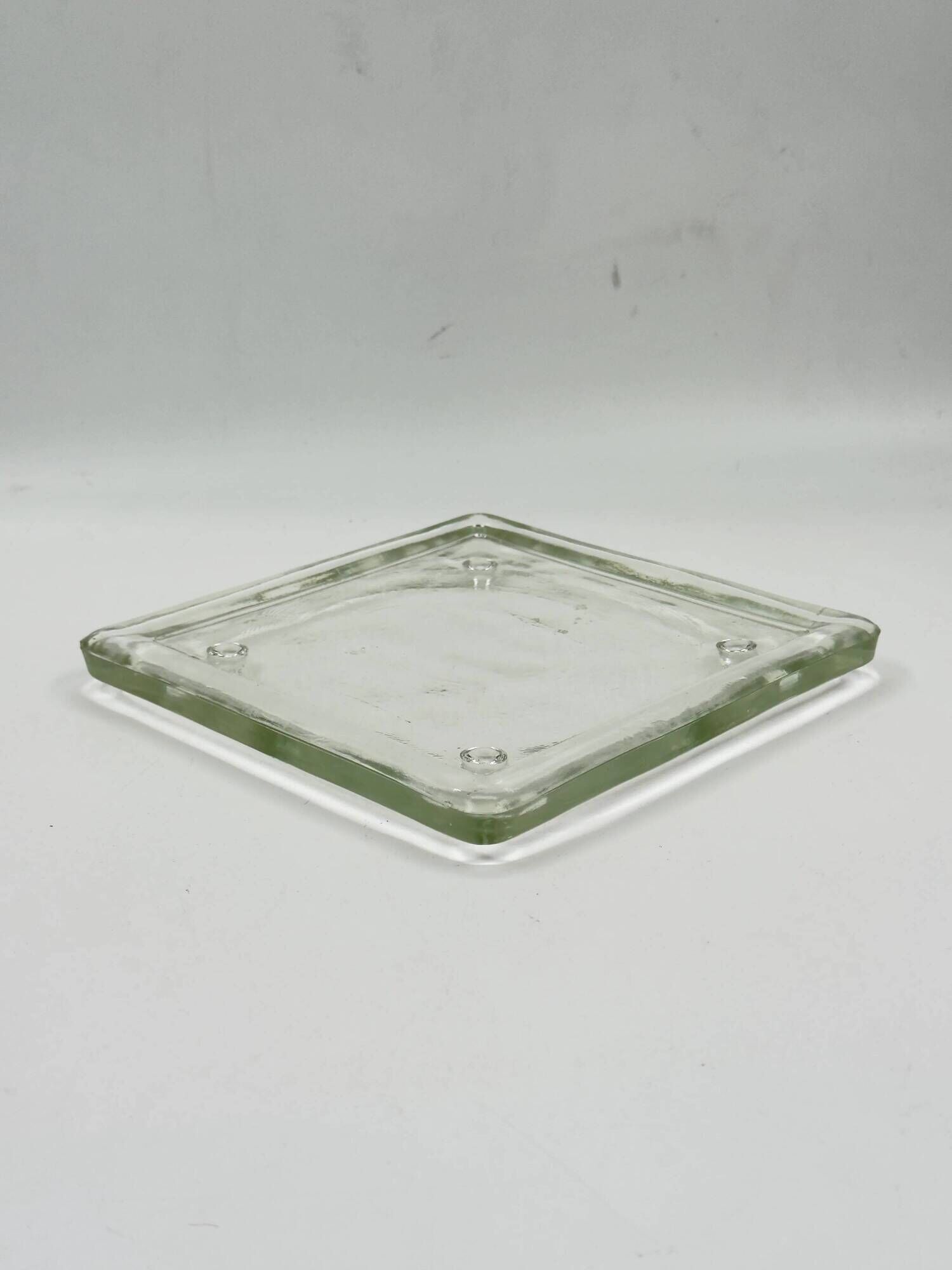 Vintage square serving tray in pale green tinted transparent glass with raised feet.