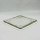 Vintage square serving tray in pale green tinted transparent glass with raised feet.