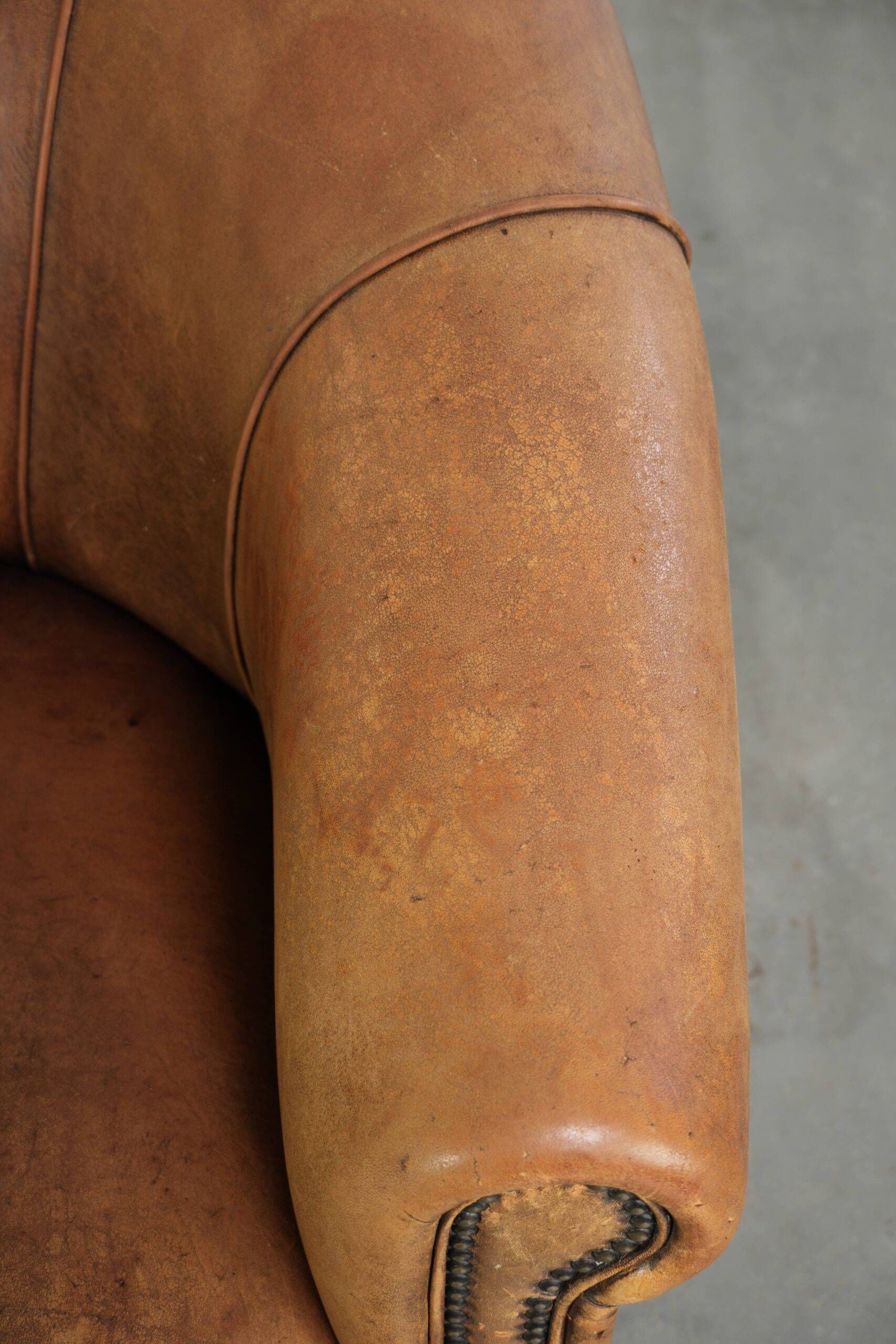 Aged sheepskin clubchair with beautiful vintage patina and comfortable seat