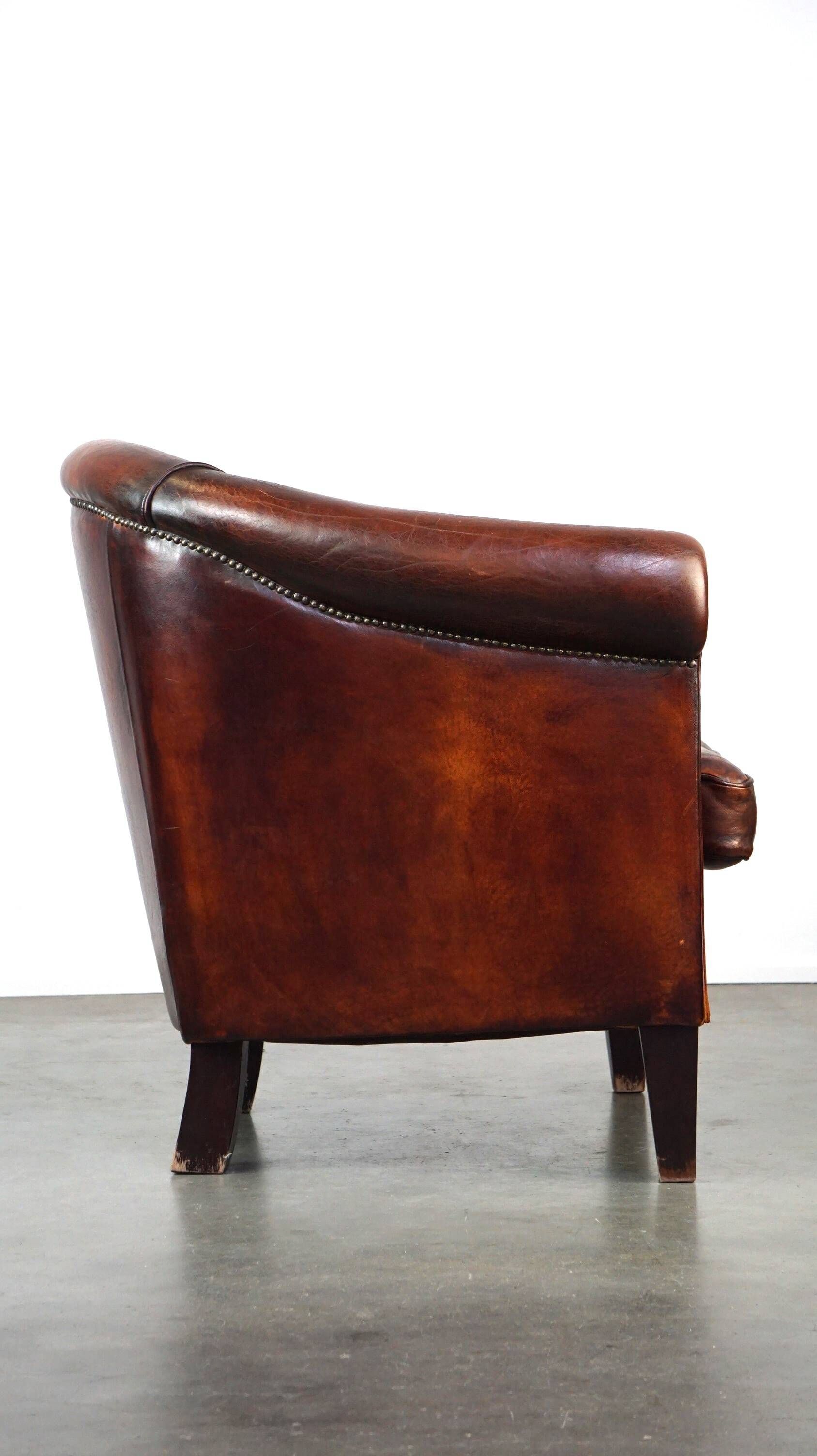 Very luxurious dark brown sheepskin club chair with a more than beautiful patina