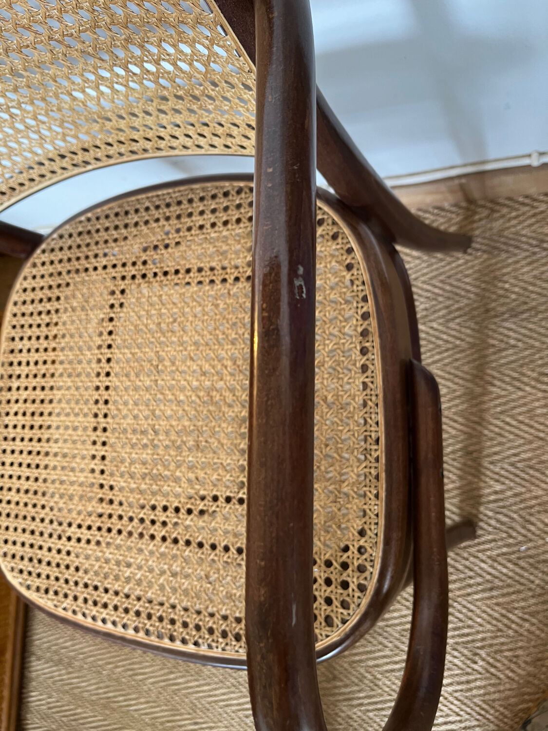 Curved wood and cane armchair