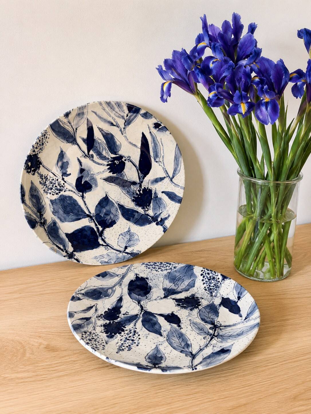 Two flat plates in earthenware with blue floral decoration.