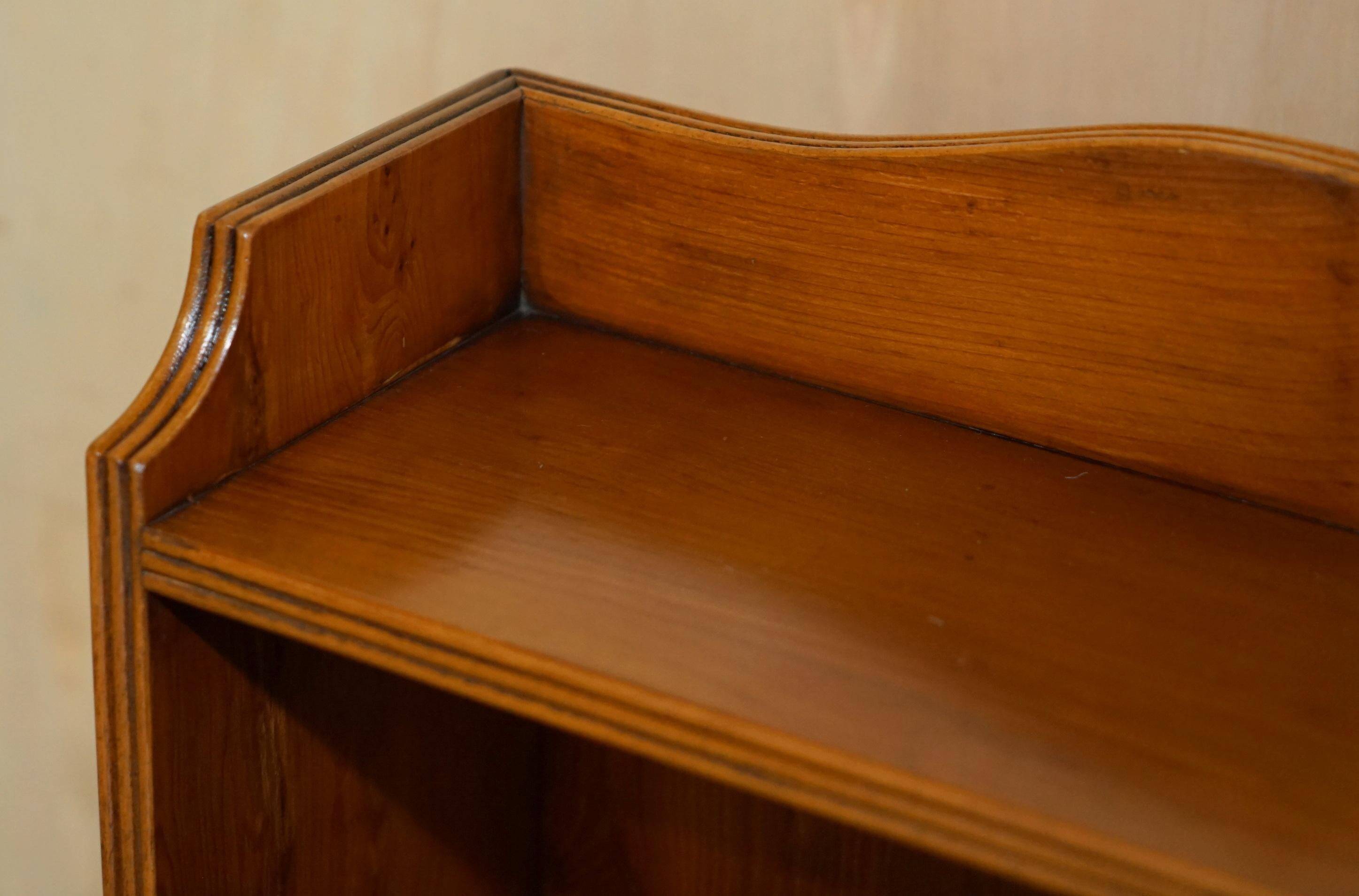 Pair of vintage English hardwood bookcases in a cascade style with cupboards.