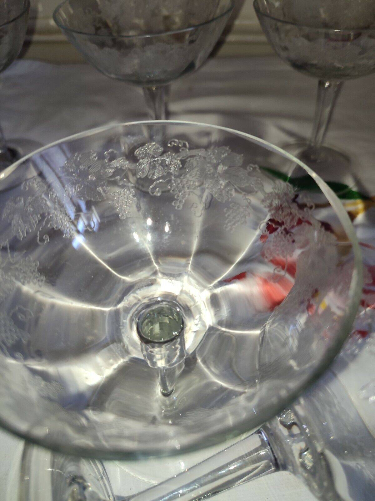 Beautiful set of seven crystal champagne glasses engraved with vine branches