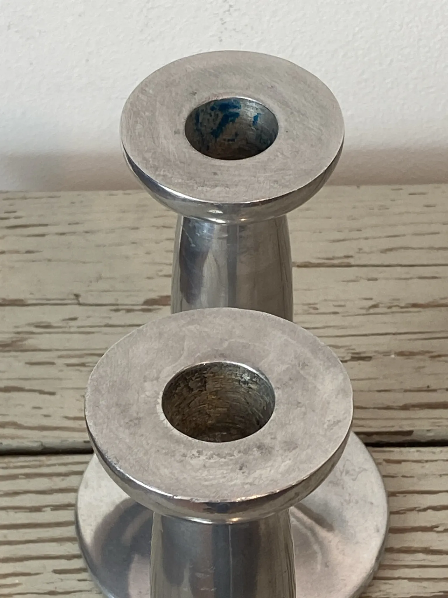 Pair of minimalist polished aluminium candle holders