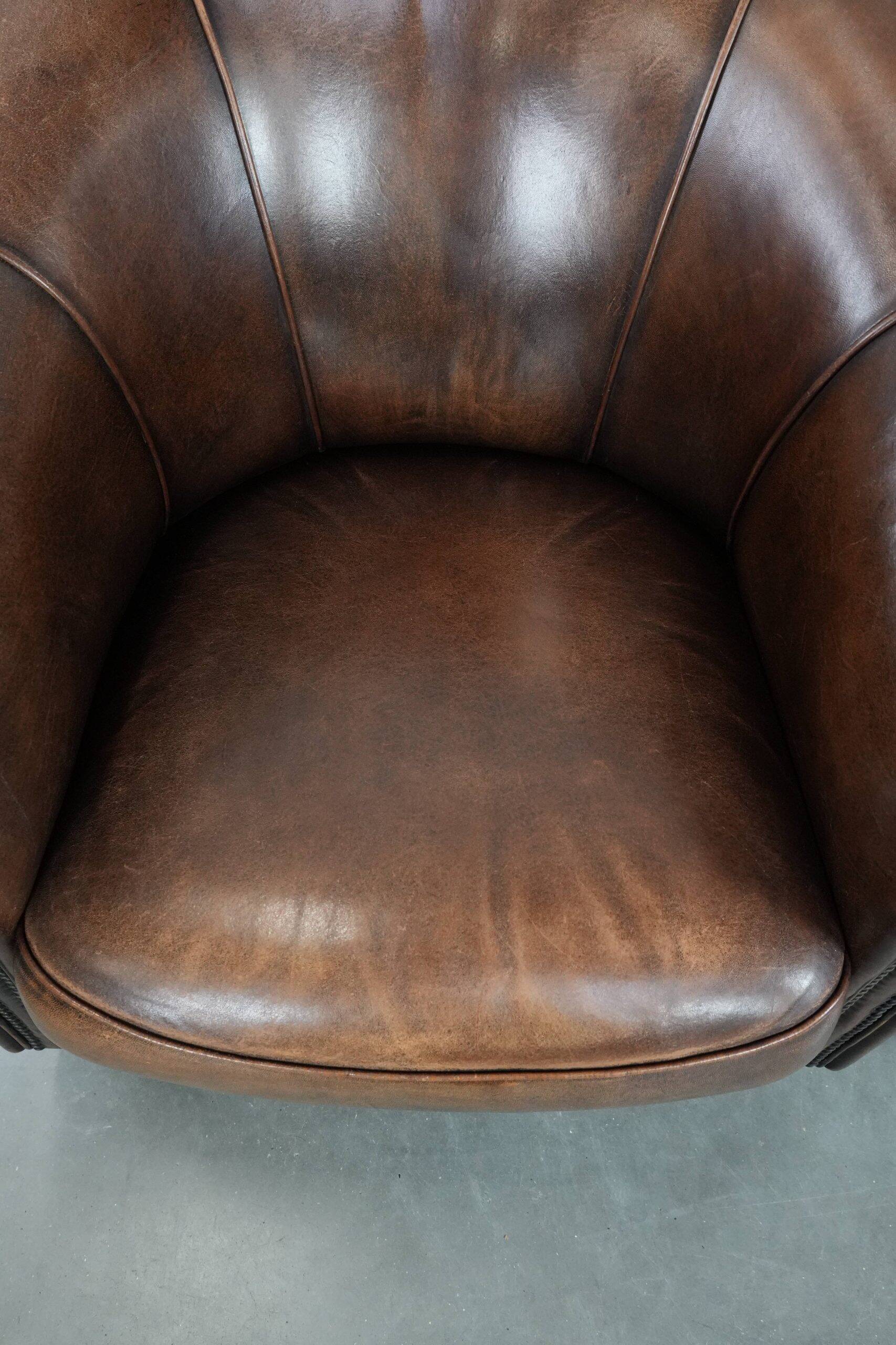 Set of two sheepskin club armchairs with fixed seat cushions