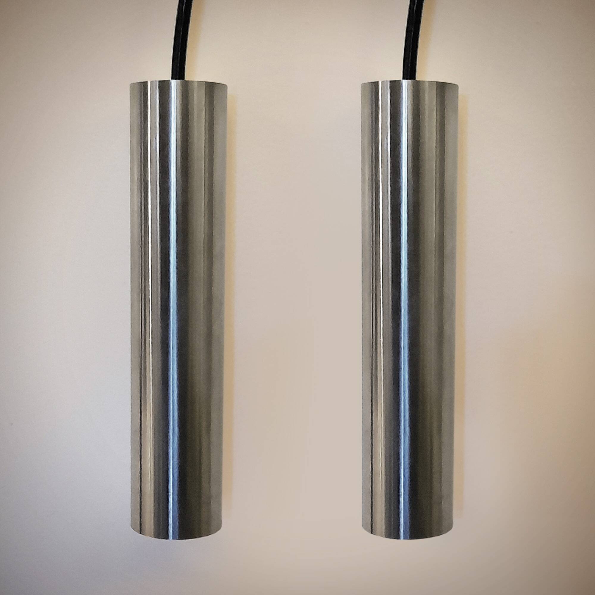Pair of still tube pendant lights in polished stainless steel, 1970s, new