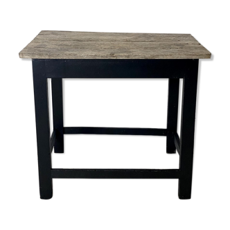 Old blackened wood work table and varnished top