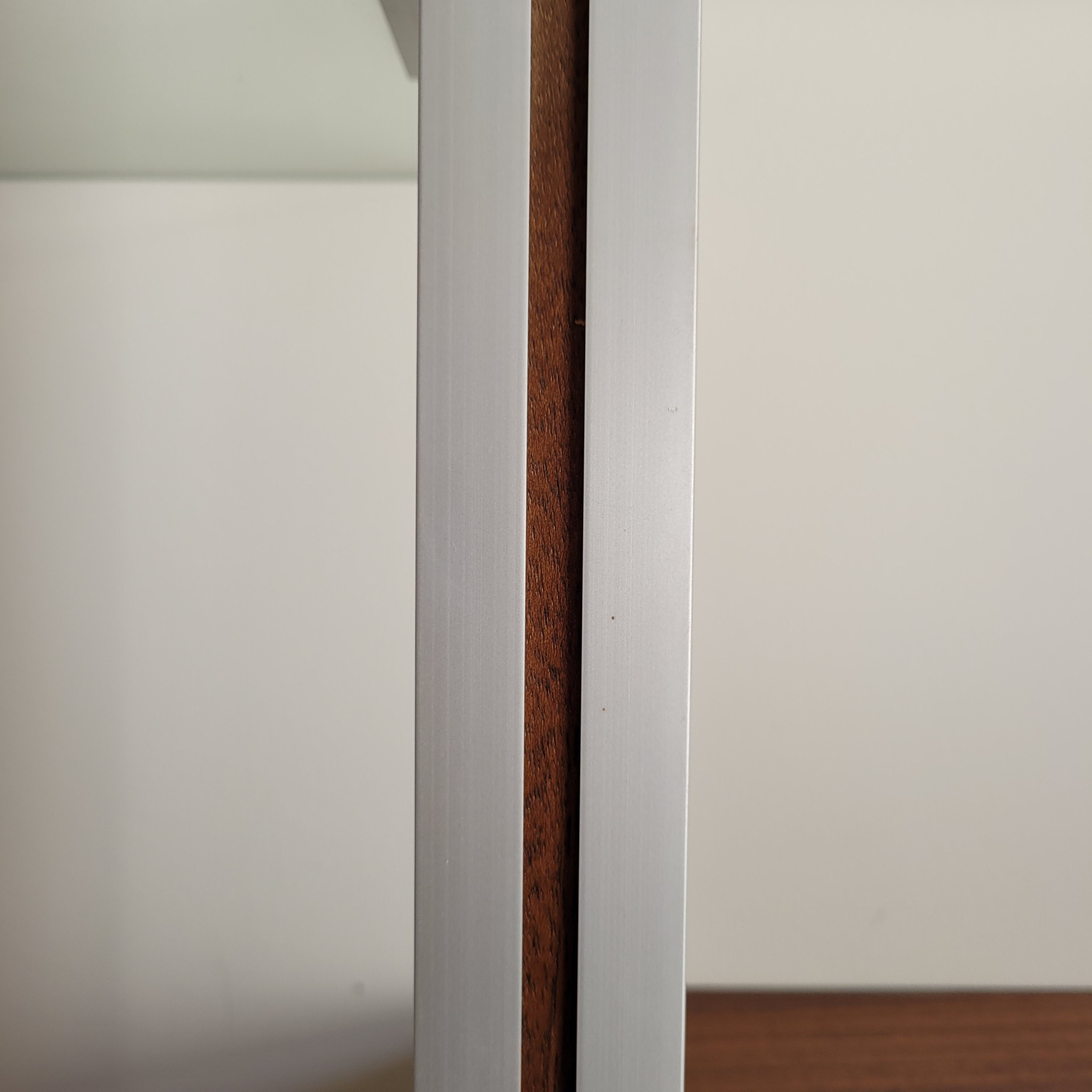 Large Scandinavian wall-mounted wood and aluminum bookcase circa 1960