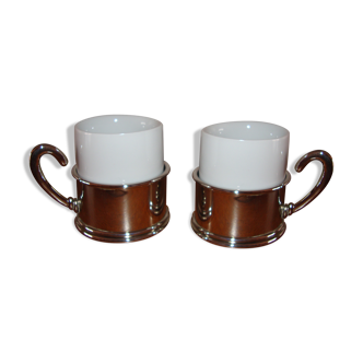 Duo of white ceramic coffee cups metal support