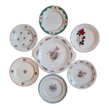7 mismatched antique dessert plates accompanied by a pie dish