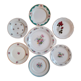 7 mismatched antique dessert plates accompanied by a pie dish