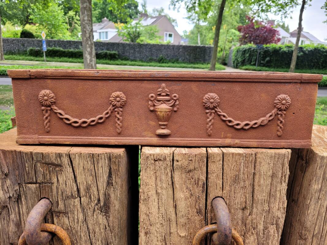 Rusty cast iron jardiniere planter