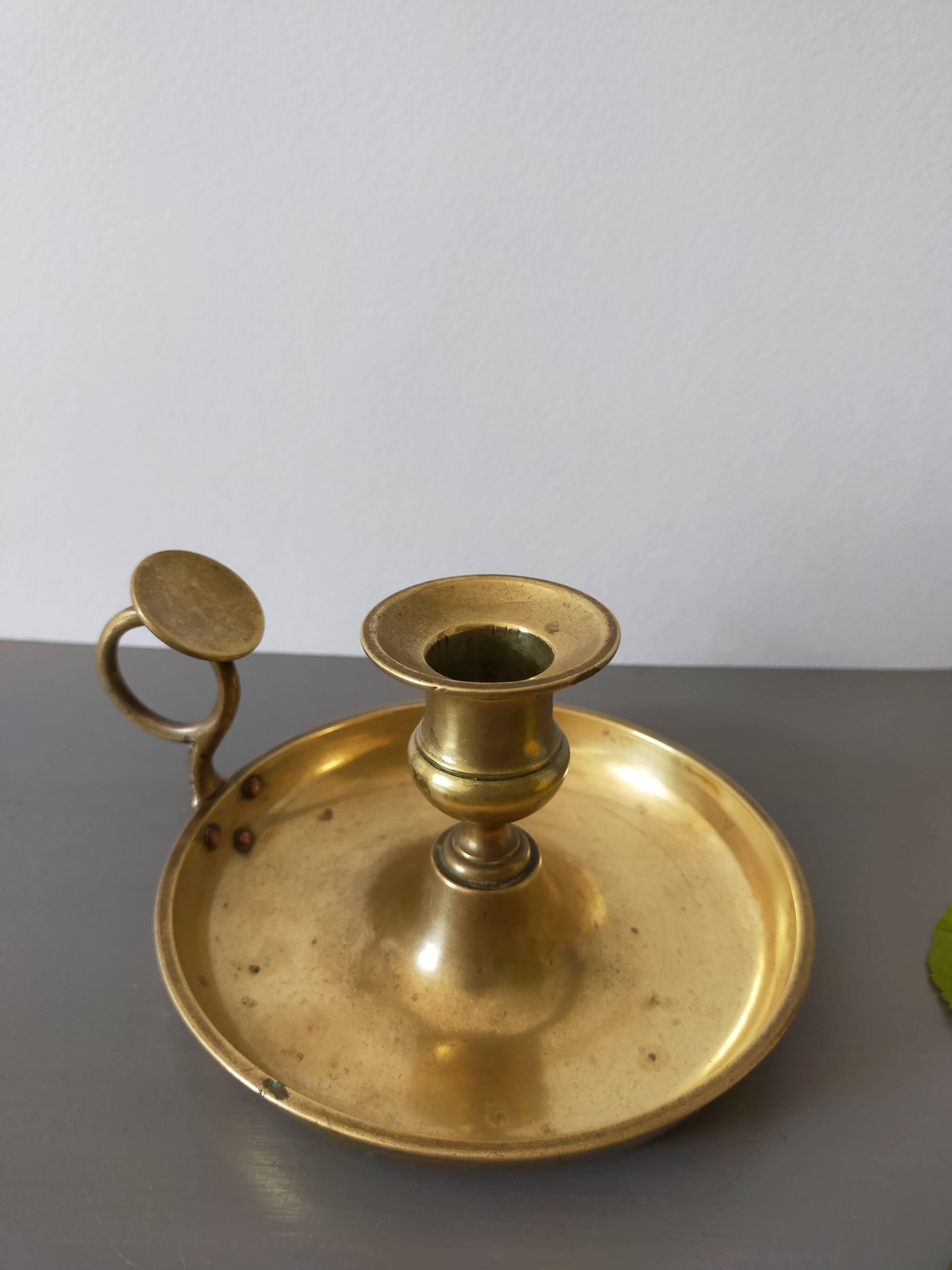 brass candle holder with old cellar rat thumb