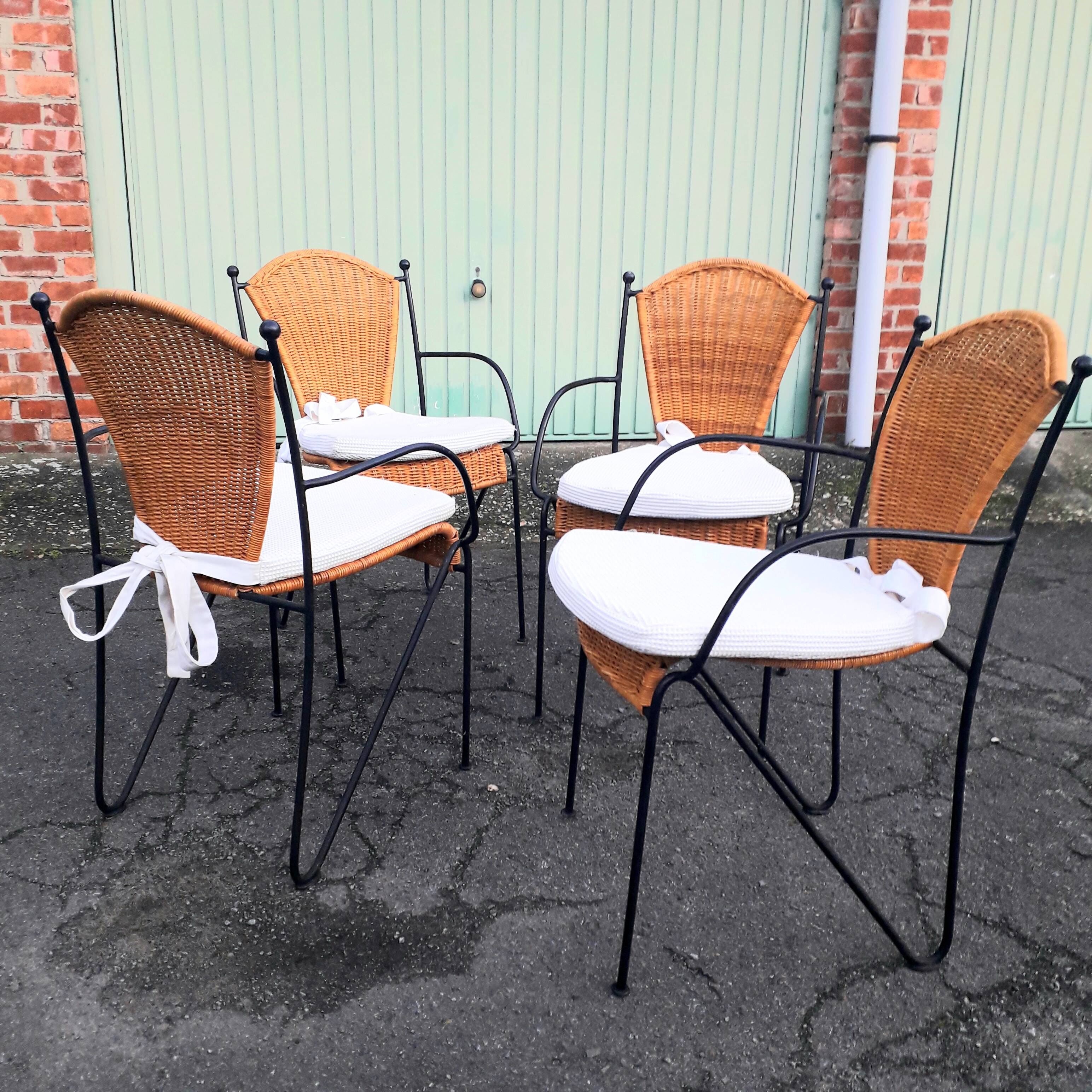 4 vintage wrought iron rattan chairs.