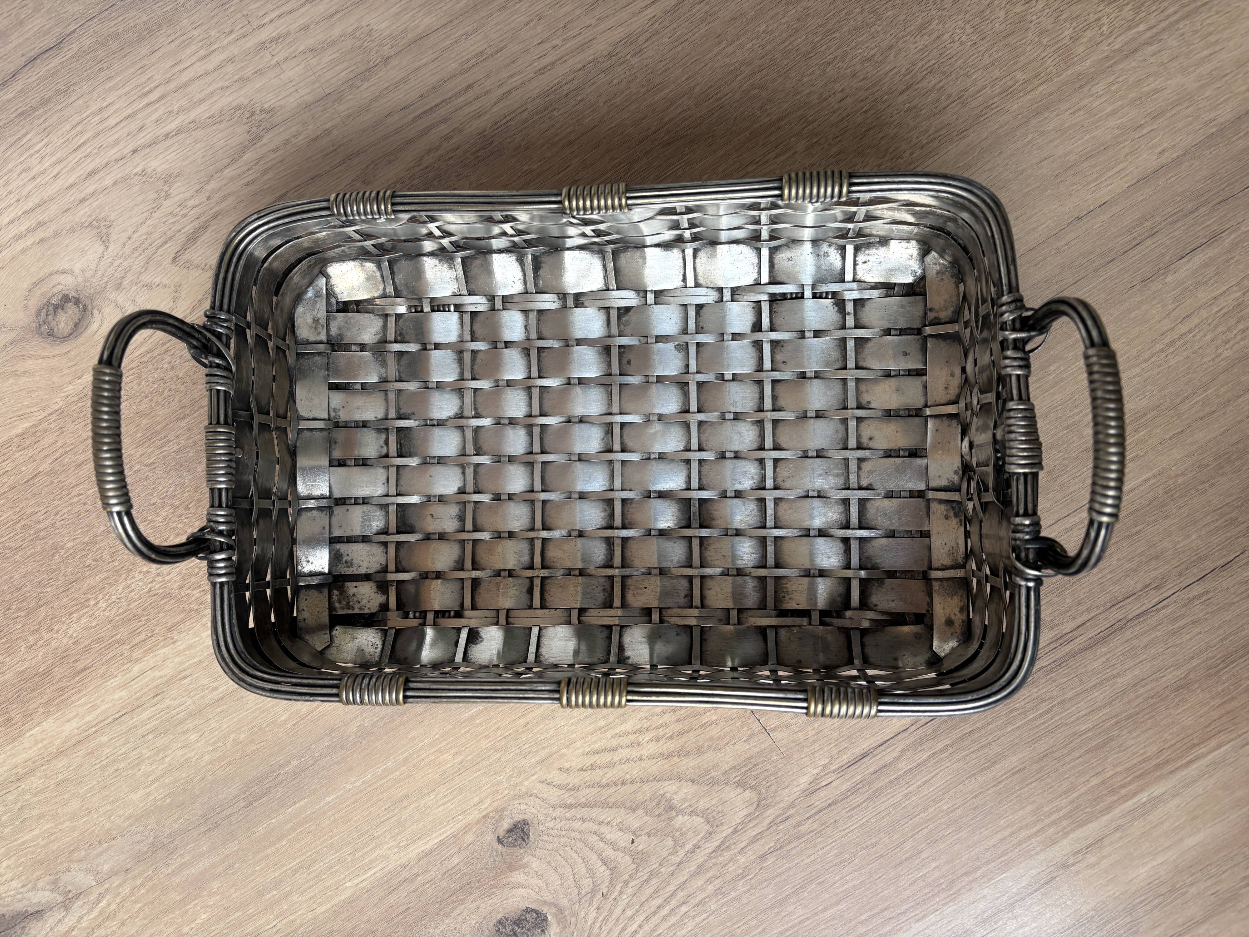 Woven silver-plated metal basket.