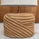 Oval table lamp in handcrafted ceramic with draped effect.