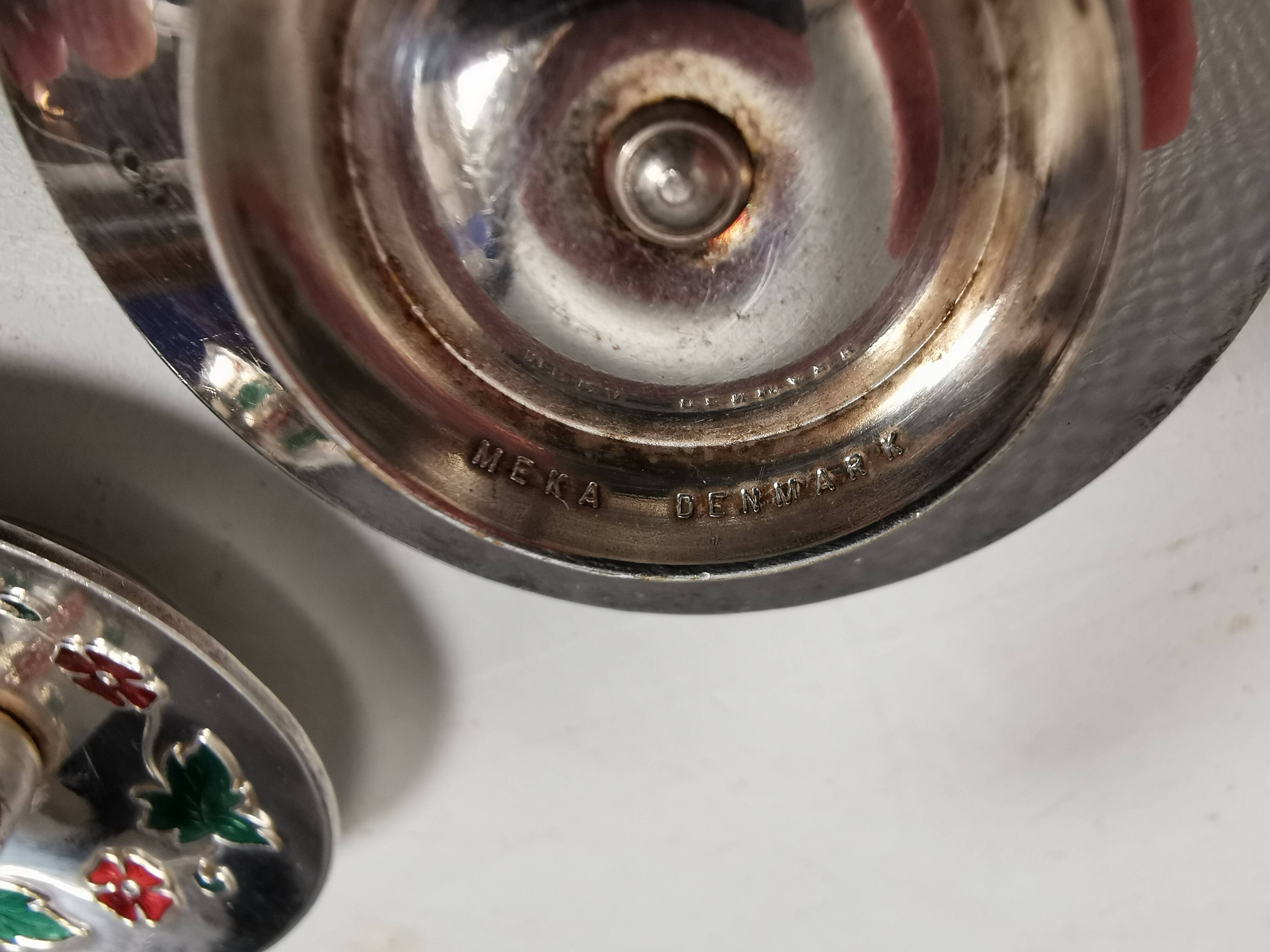 Silver-plated candle holders with inlaid red and green enamel
