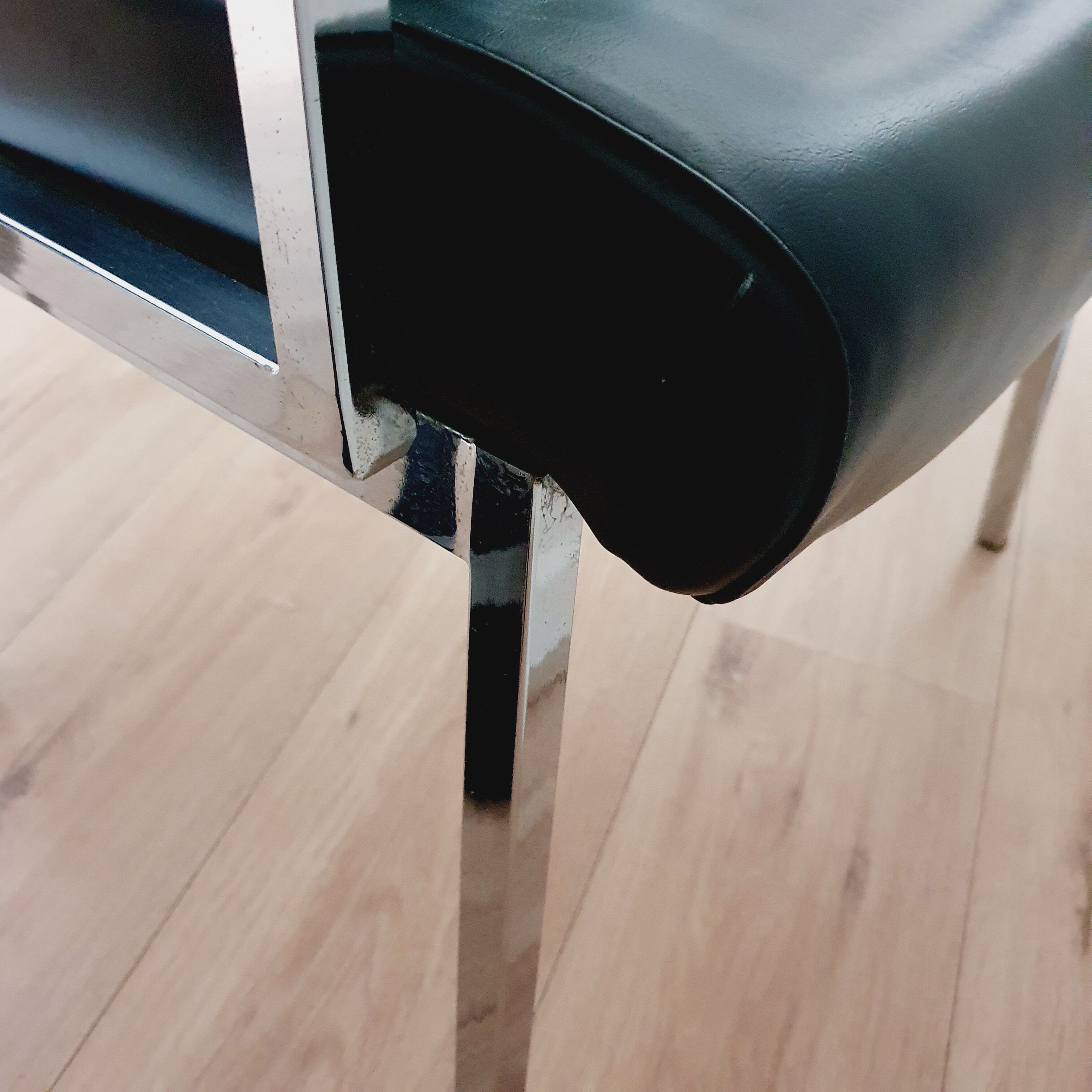 Pair of black skaï and chrome armchairs