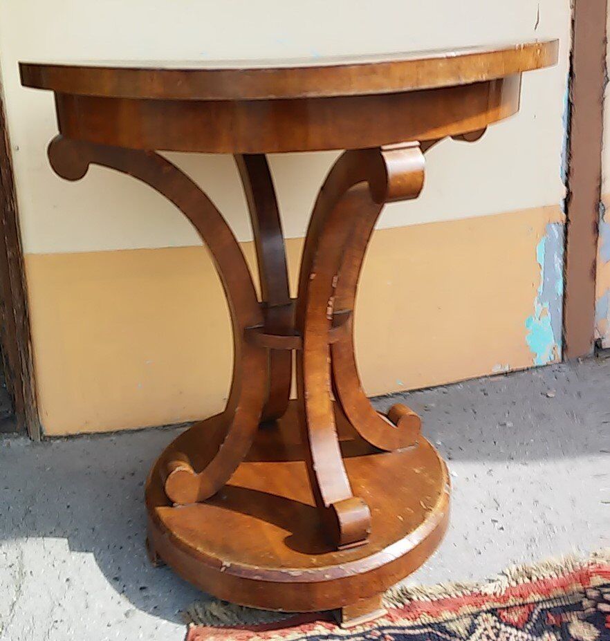 Art Deco side table in brown walnut, round top and scroll legs, France 1930s.