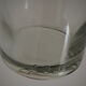 Bottle with mechanical closure in white glass and porcelain stopper.
