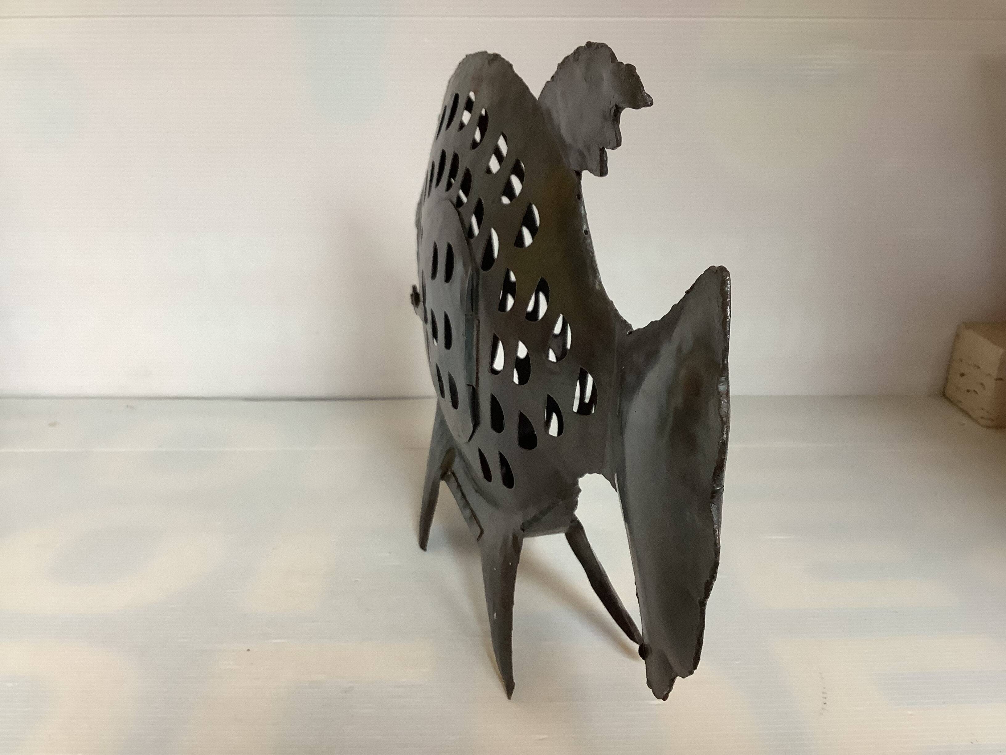 Large metal fish-shaped candle holder