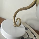 Swan neck wall light in brass with a white glass shade.