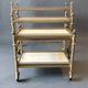 Neoclassical nesting trolleys in gilded brass and peach marble 1950/1960.