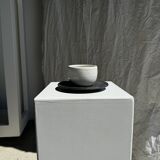 White Indonesian ceramic cup and gray saucer