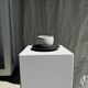 White Indonesian ceramic cup and gray saucer