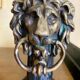 Pair of antique fire dogs with lion heads - patinated cast iron