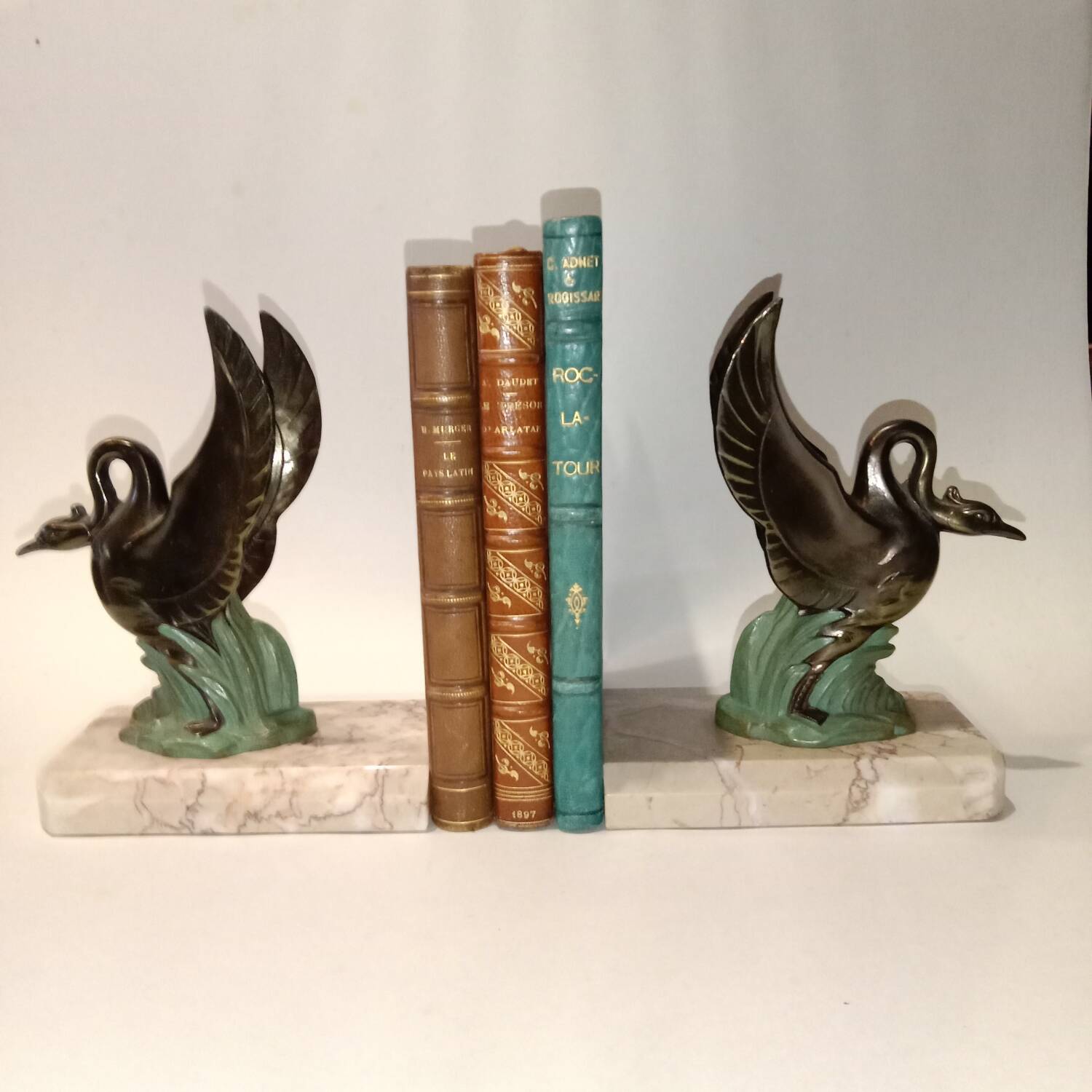 Art Deco bookends with metal swans, double patina and marble base.