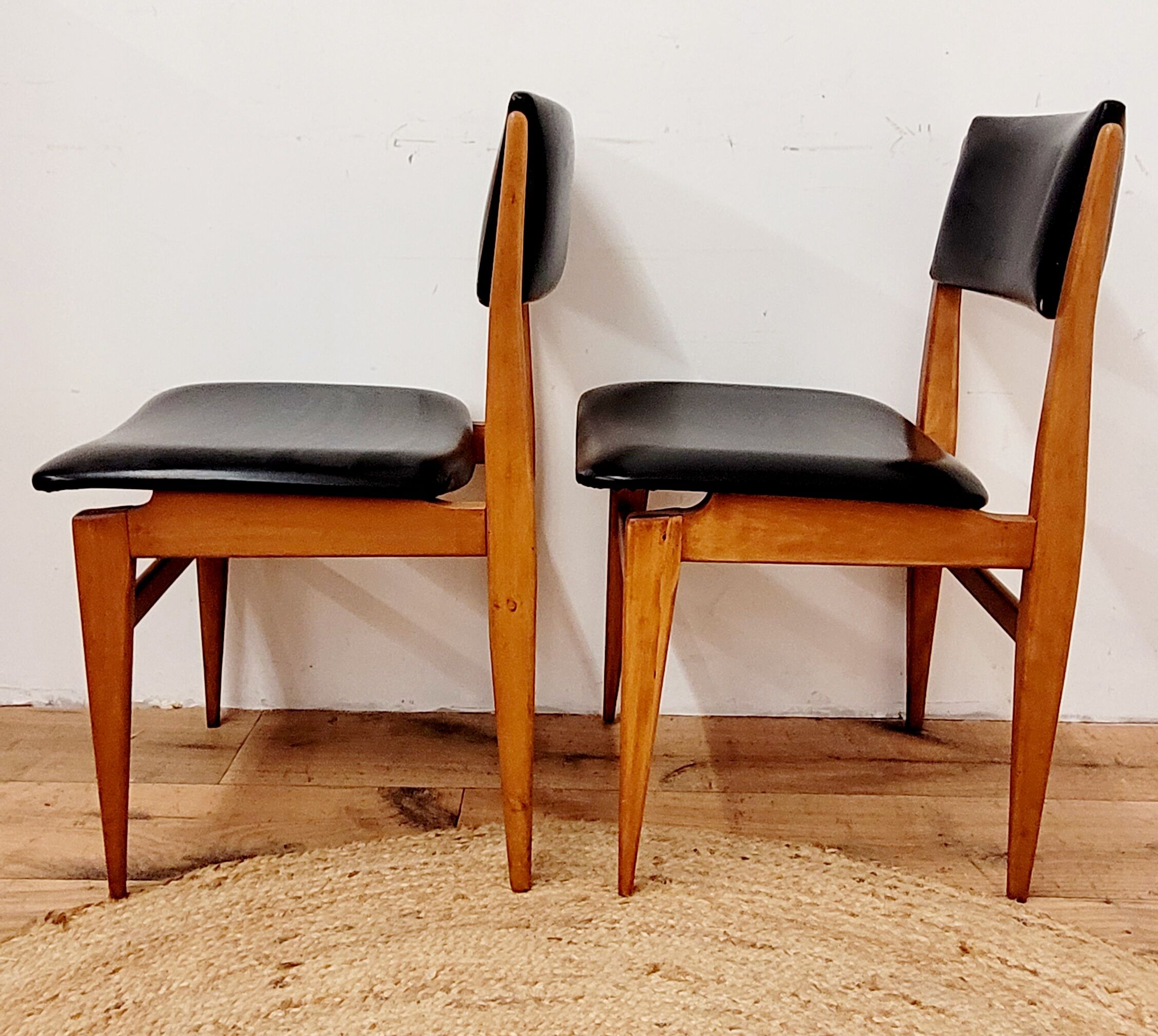 Six vintage wooden chairs and black Skaï
