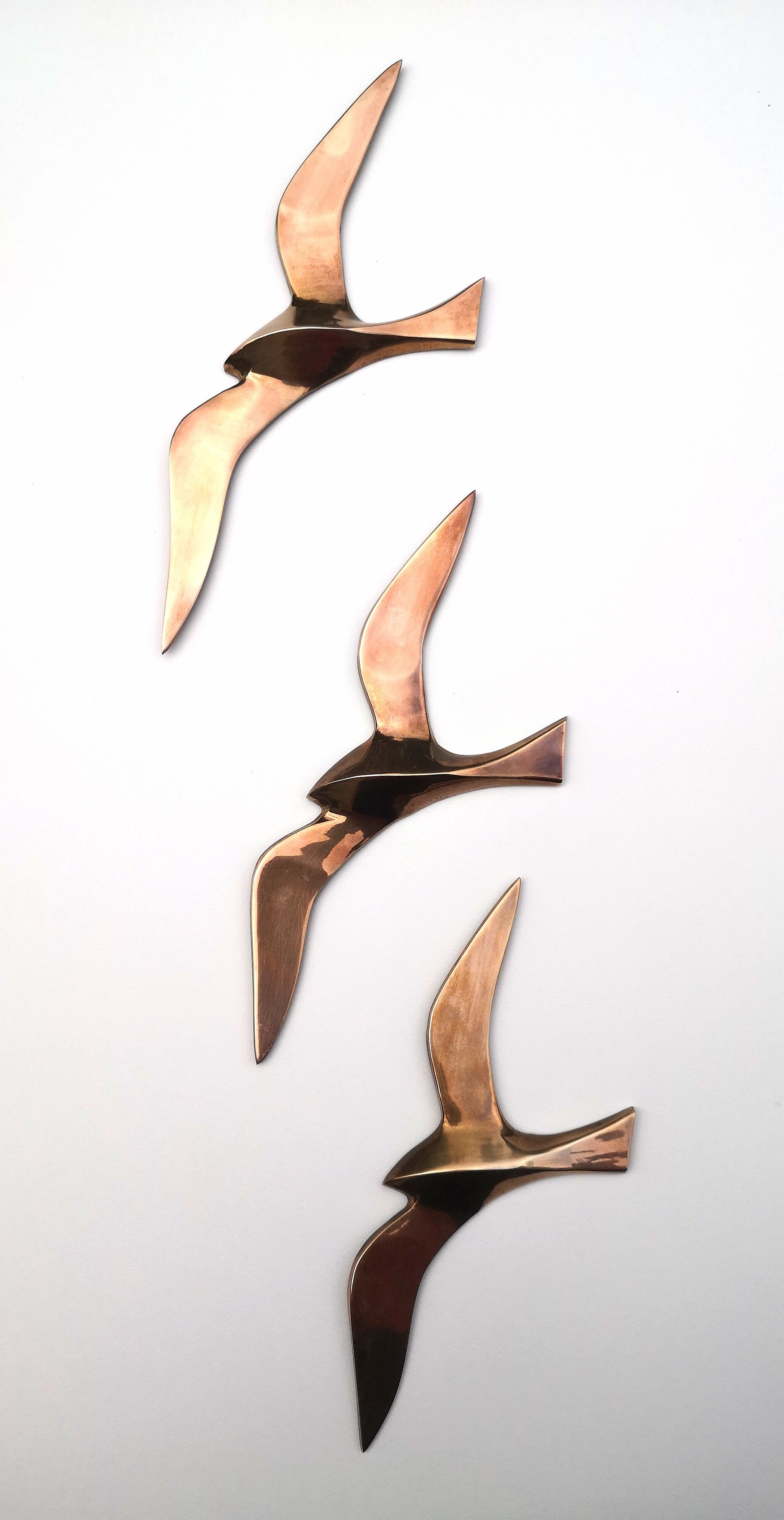 Birds stylized in brass