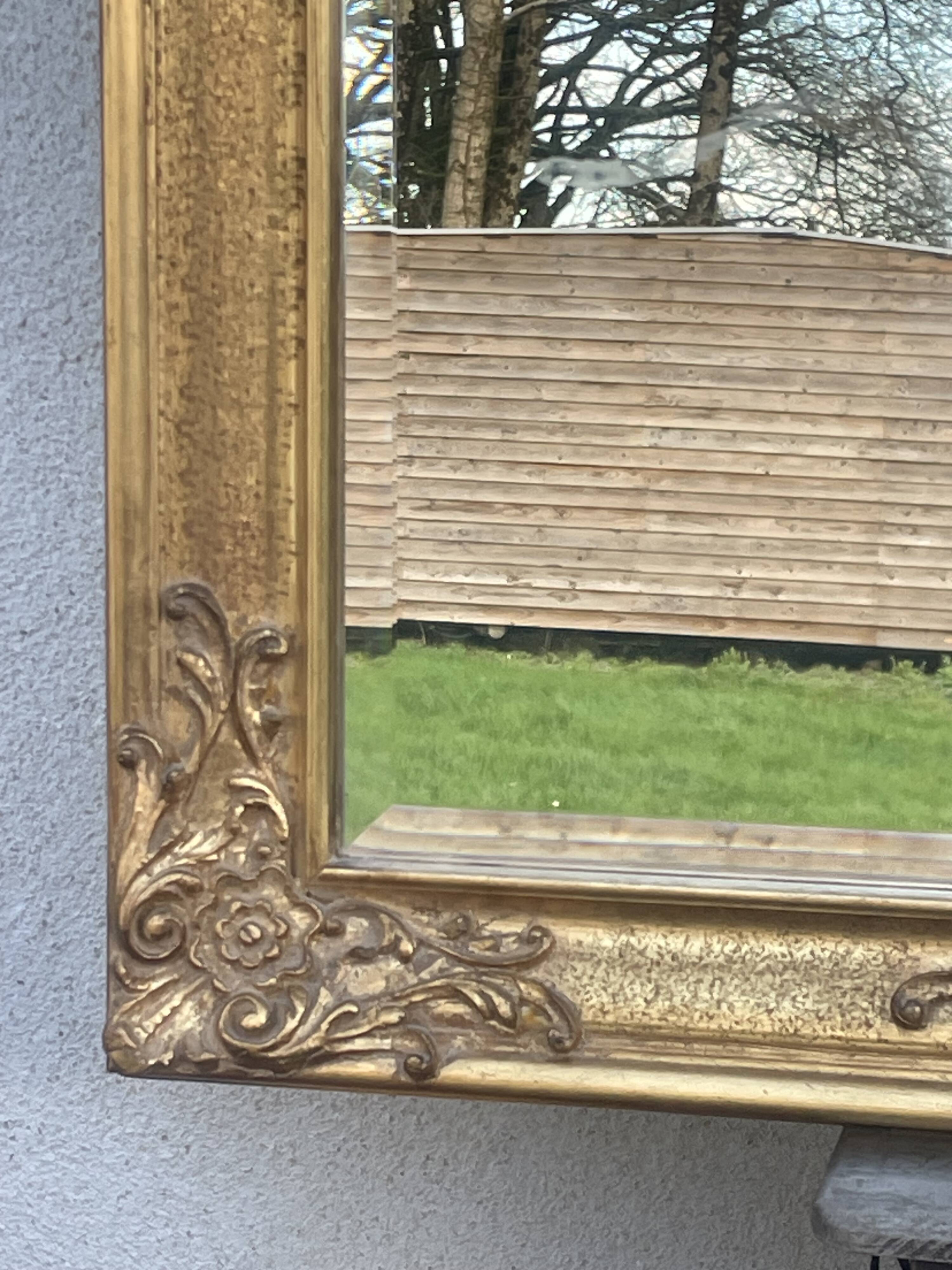 vintage bevelled mirror in rectangular shape, stucco and gilded wood in Louis XV baroque style