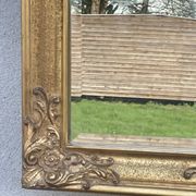 vintage bevelled mirror in rectangular shape, stucco and gilded wood in Louis XV baroque style