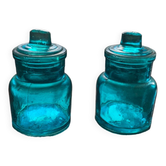 Two small turquoise blue glass jars