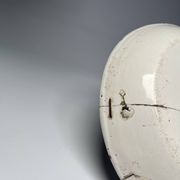 Two antique 18th-century faience plates, stapled.